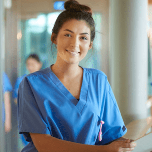 Female nurse holding a file poses for the camera